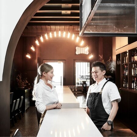Liling Ong and her cousin, Chef Lim Yew Aun man and woman smiling in a restaurant