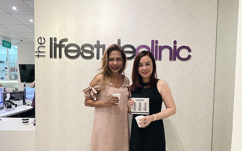 With Dr Komathy from The Lifestyle Clinic Singapore Kersie with Dr Komathy from The Lifestyle Clinic Singapore holding the Cyspera products