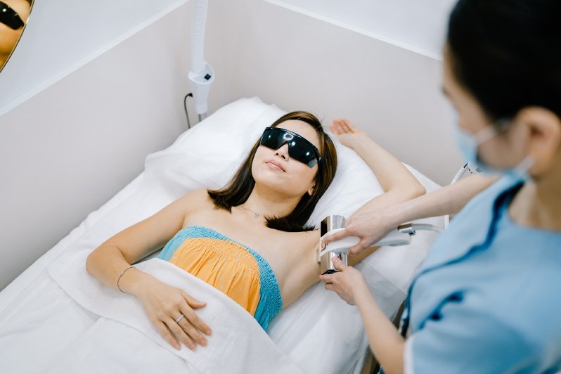A girl getting IPL hair removal on her underarms